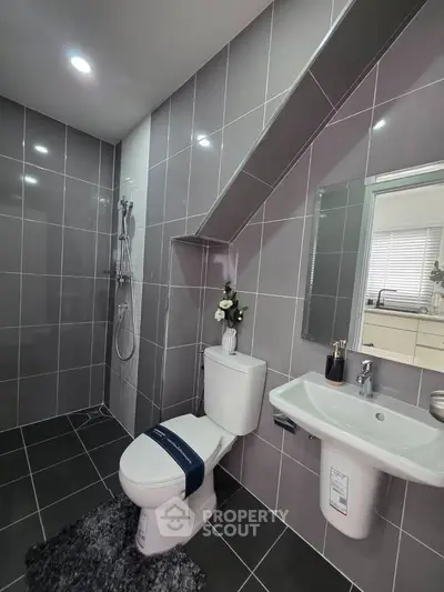 Modern bathroom with sleek gray tiles and stylish fixtures