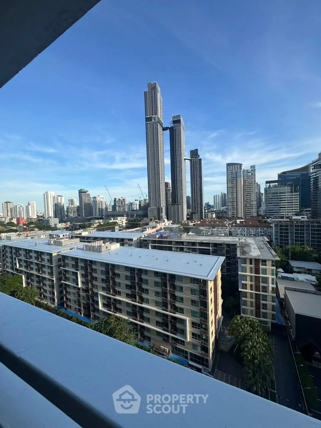 Stunning cityscape view from a high-rise balcony showcasing modern skyscrapers and urban skyline.