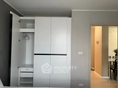 Modern apartment interior with open wardrobe and dining area view