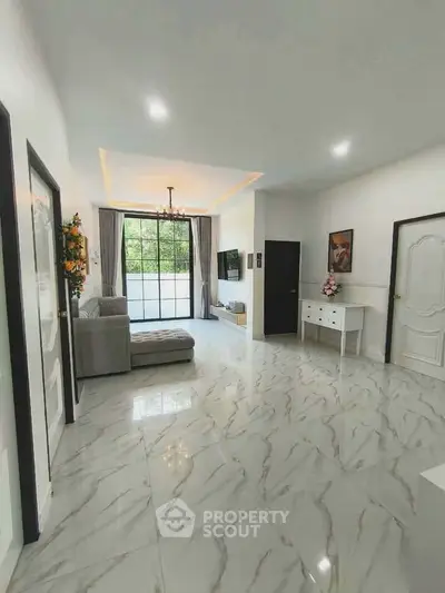 Spacious living room with elegant marble flooring and large window view