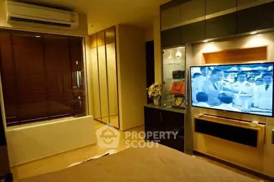 Modern bedroom with air conditioning and wall-mounted TV in cozy apartment.