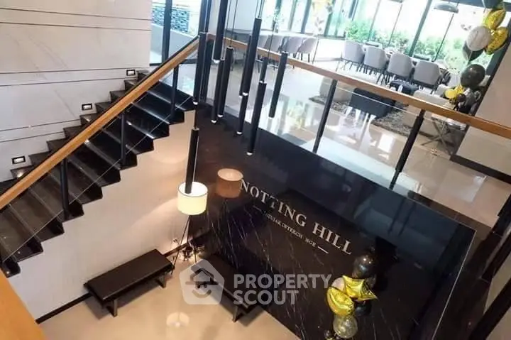 Luxurious modern building entrance with elegant staircase and stylish decor
