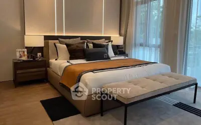 Luxurious bedroom with elegant decor and large windows for natural light.