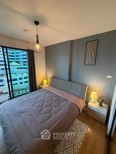Modern bedroom with stylish decor and city view, featuring cozy lighting and elegant furnishings.