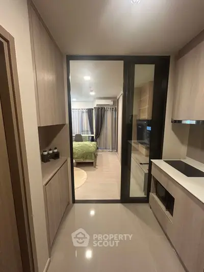 Modern apartment interior with sleek kitchen and cozy bedroom view