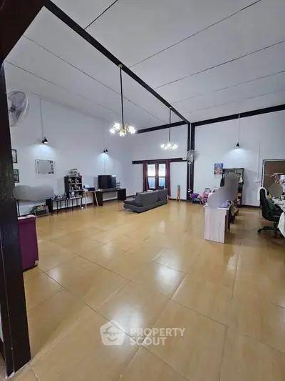 Spacious living room with high ceilings and modern decor, perfect for family gatherings.