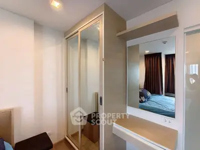 Modern bedroom with mirrored wardrobe and cozy decor