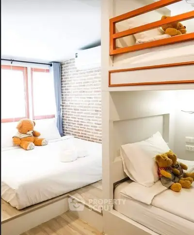 Charming bedroom with cozy bunk beds and teddy bear decor, perfect for a warm family home.