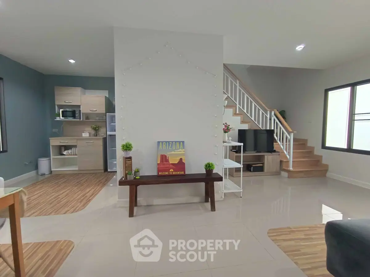 Spacious modern living room with open kitchen and stylish staircase