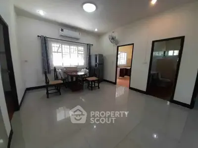 Spacious dining area with modern furnishings and natural light, perfect for family gatherings.
