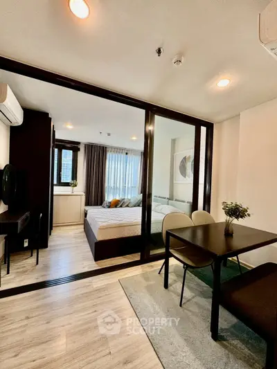 Modern open-plan bedroom with dining area and stylish decor