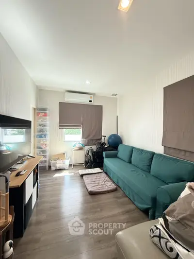 Cozy living room with modern decor and ample natural light