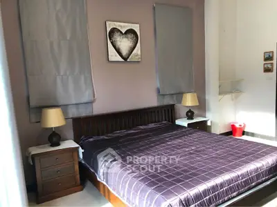 Cozy bedroom with modern decor and ample natural light