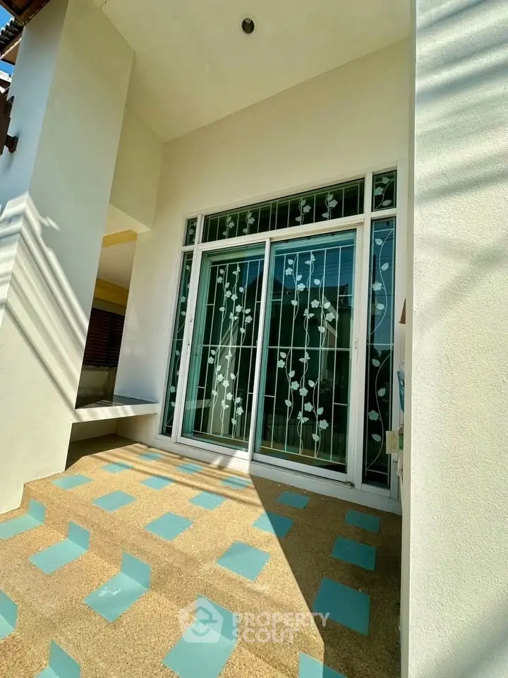 Charming entrance with decorative glass doors and patterned flooring, perfect for a welcoming home ambiance.