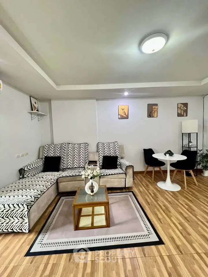 Stylish living room with modern decor and cozy seating area, perfect for relaxation and entertaining.