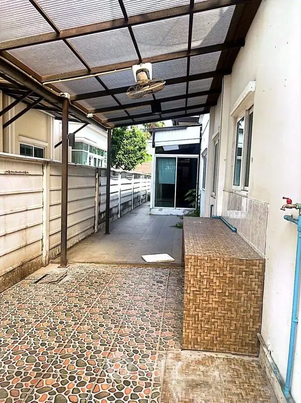 Charming covered outdoor space with tiled flooring and modern design elements.