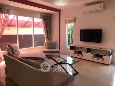 Elegant living room with modern furniture and large windows