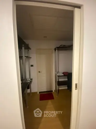 Cozy interior view of a compact room with bunk bed and study area, perfect for efficient living.