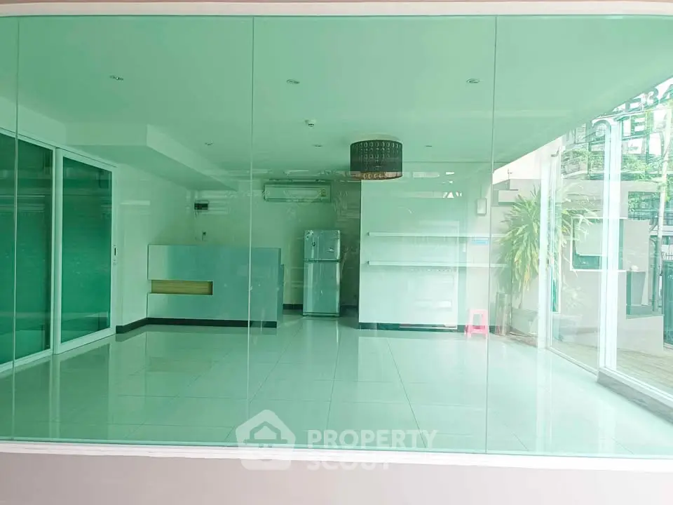 Spacious modern interior with large glass windows and sleek design, perfect for versatile use.
