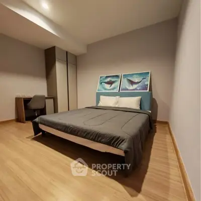 Spacious modern bedroom with stylish decor and wooden flooring
