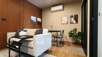 Modern living room with cozy sofa, dining table, and stylish decor in a contemporary apartment.