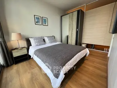 Modern bedroom with stylish decor and wooden flooring