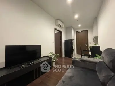 Modern living room with sleek furniture and hardwood floors in a stylish apartment.