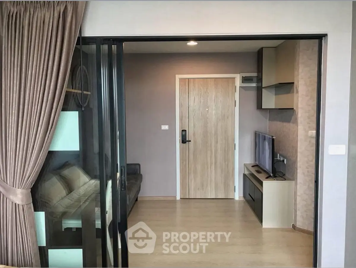 Modern apartment interior with sliding glass doors and cozy living area