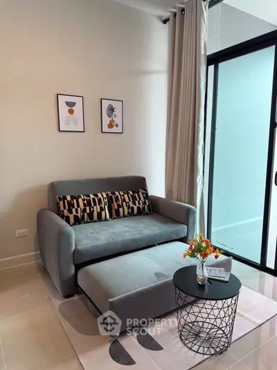 Modern living room with stylish sofa and glass door balcony access