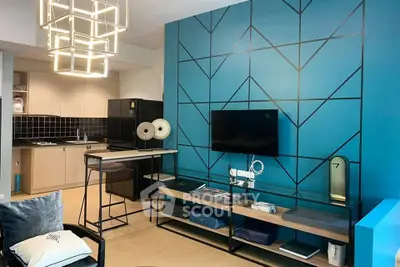 Modern living room with stylish geometric accent wall and open kitchen layout