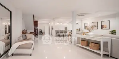 Spacious open-plan living room with modern decor and sleek design