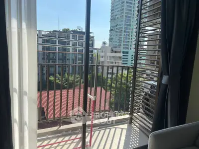 Charming city view from a modern apartment balcony with sleek railing design.