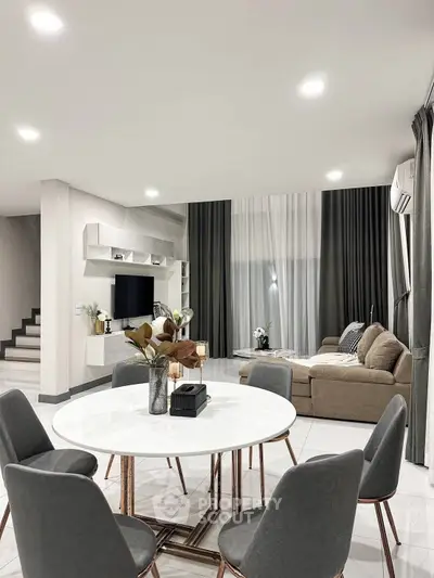Modern living room with elegant dining area and stylish decor