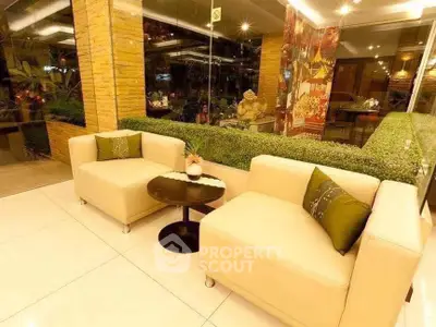 Elegant modern living room with plush sofas and glass walls, perfect for relaxation.
