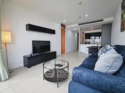 Spacious modern living room with sleek furniture and open kitchen layout in a stylish apartment.