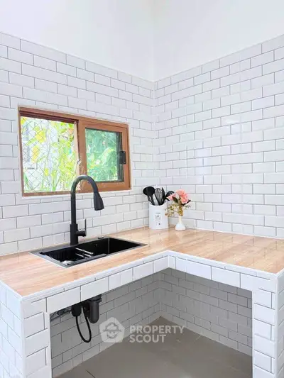 Modern kitchen with sleek black faucet and white subway tiles