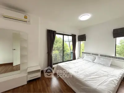 Bright and airy bedroom with large windows and modern furnishings