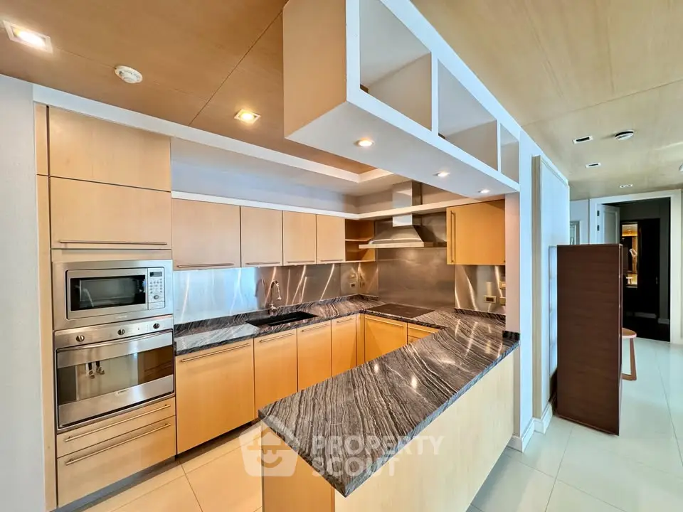 Luxurious modern kitchen with sleek cabinetry and high-end appliances in a stylish open layout.
