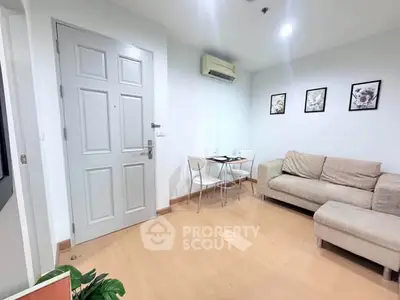 Cozy living room with modern decor and comfortable seating in a stylish apartment.