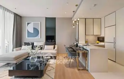 Modern open-plan living room and kitchen with elegant decor and natural light.