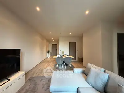 Spacious modern living room with stylish furniture and open dining area, perfect for entertaining.