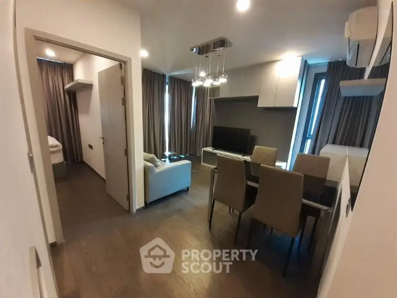 Modern living room with dining area and stylish lighting in a cozy apartment.