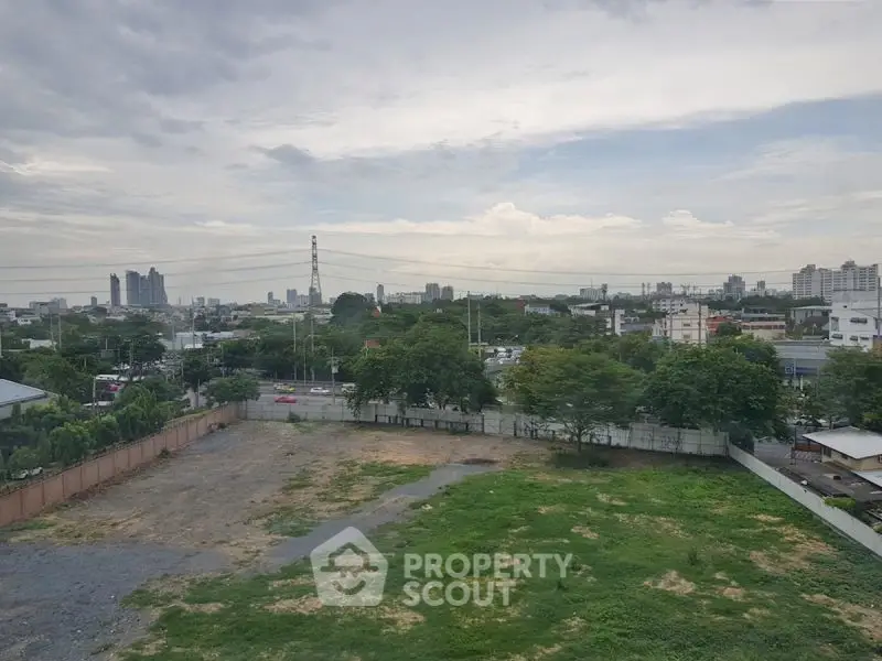 Expansive cityscape view with lush greenery and urban skyline, perfect for development opportunities.