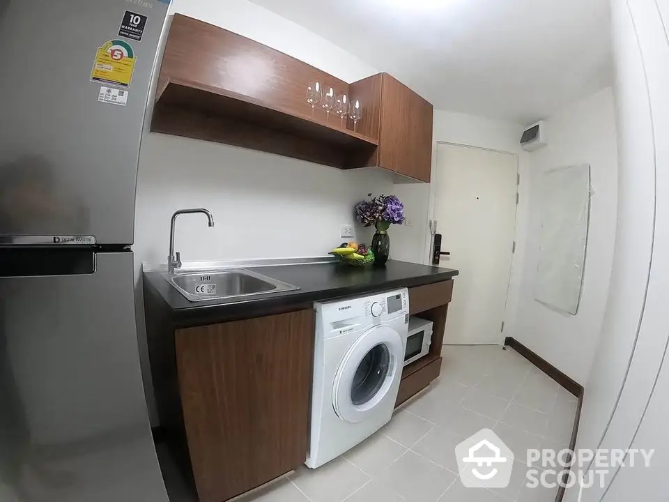 Modern compact kitchen with washing machine and wooden cabinets