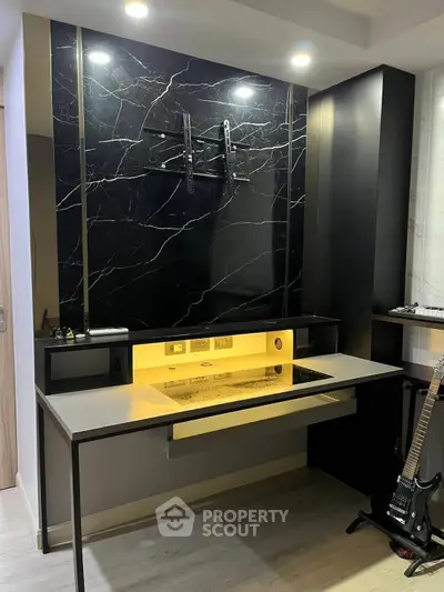 Modern study area with sleek black marble wall and built-in desk lighting