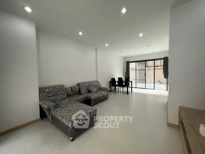 Spacious modern living room with stylish furniture and large windows for natural light.