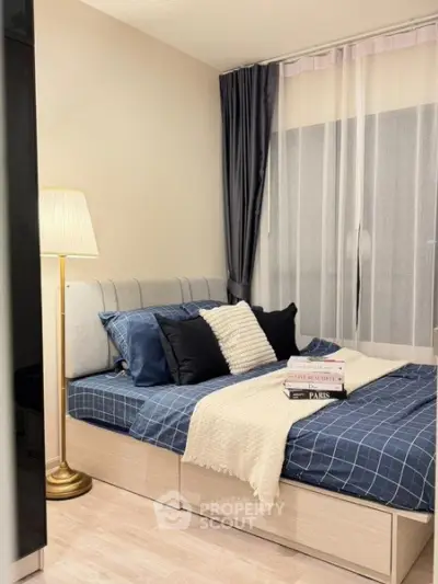 Cozy bedroom with stylish decor and natural light, perfect for relaxation and comfort.