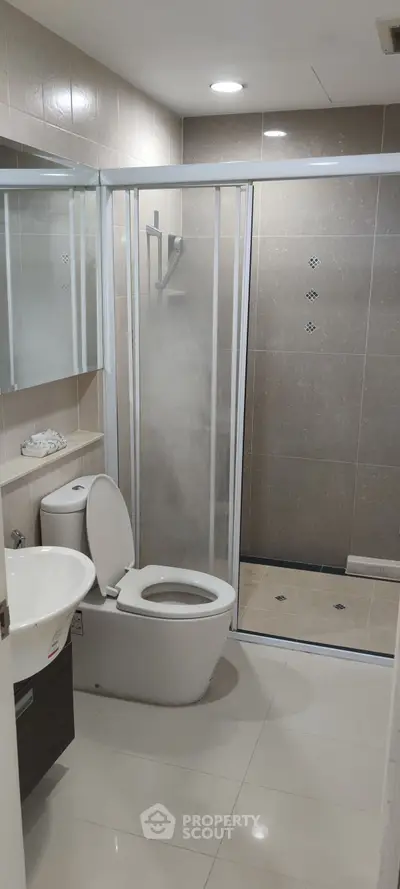 Modern bathroom with glass shower and sleek fixtures