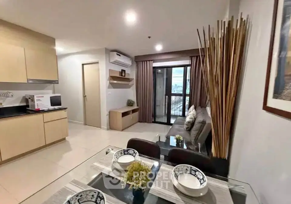 Modern open-layout living room with kitchen and balcony view
