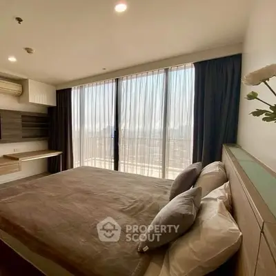 Modern bedroom with large windows and stylish decor